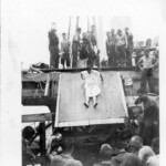 Dr. Bierley going down slide in Shellback Ceremony