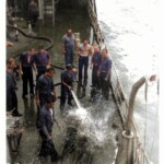 Shellbacks hosing off Polywog - Colorized